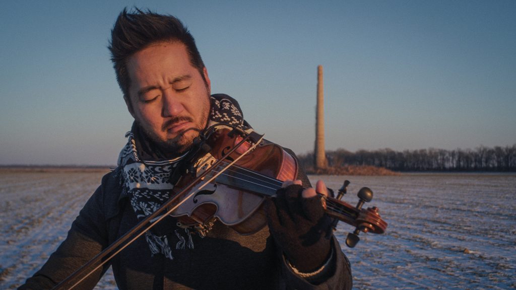 Musician & filmmaker Kishi Bashi playing the violin in his new film Omoiyari
