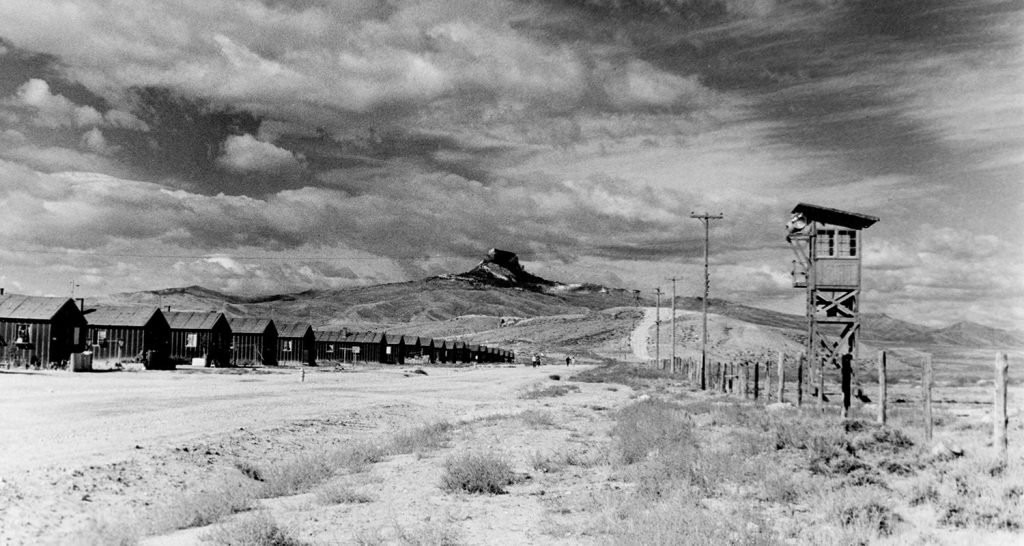 Heart Mountain background with barracks and guard tower in the foreground